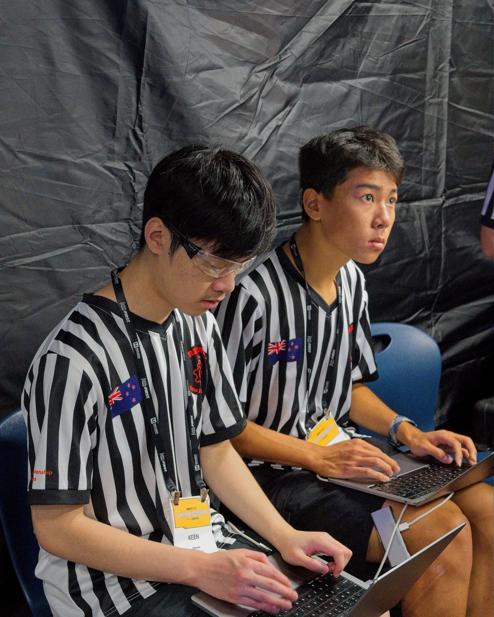 Referees team members running systems and strategy on laptops